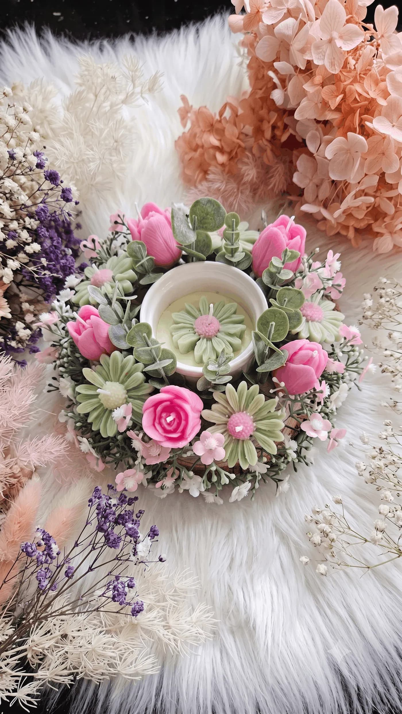 Pink rose and daisy candle arrangement styled with soft greenery