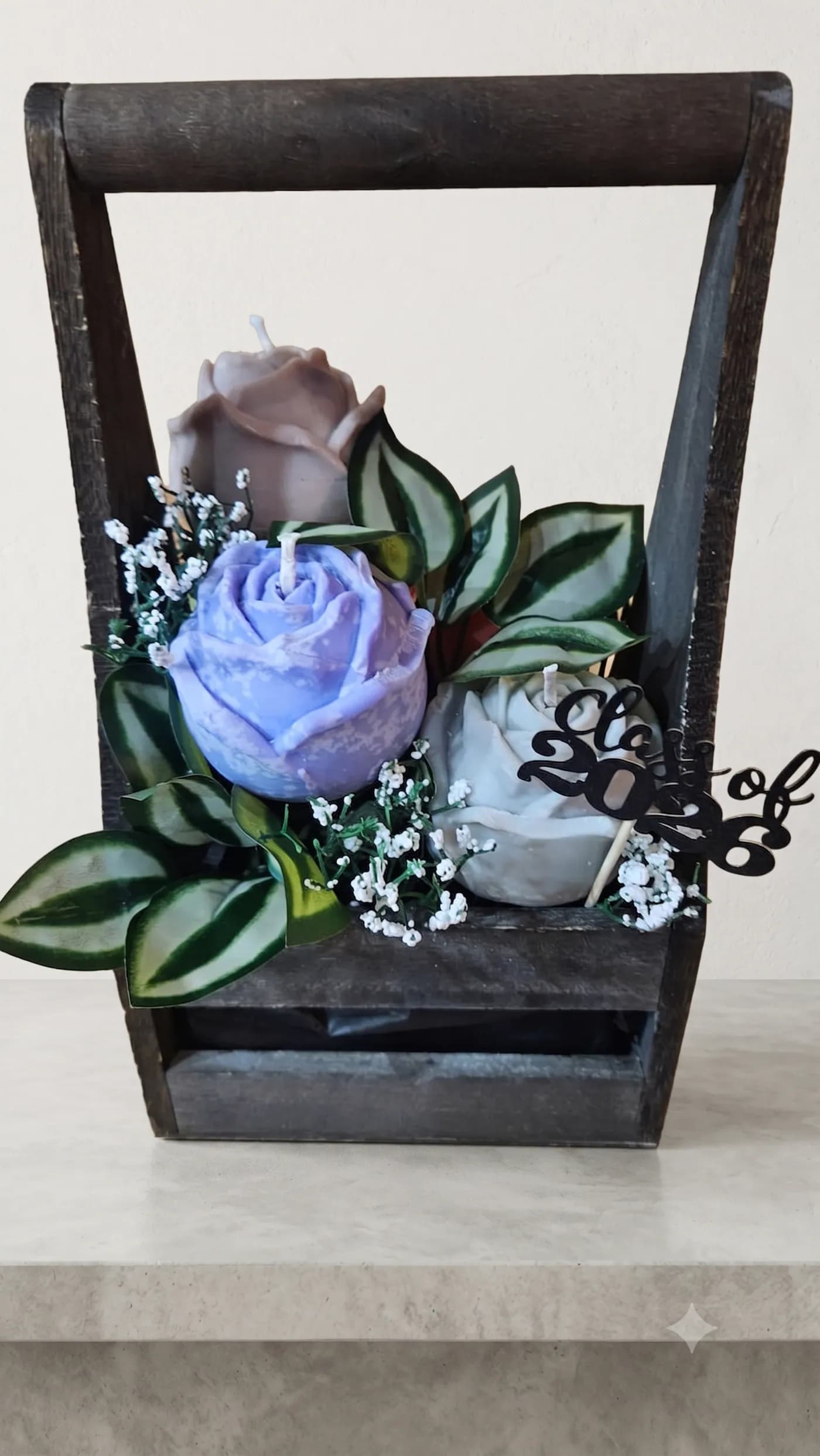 Purple rose candle arrangement in a dark wooden keepsake