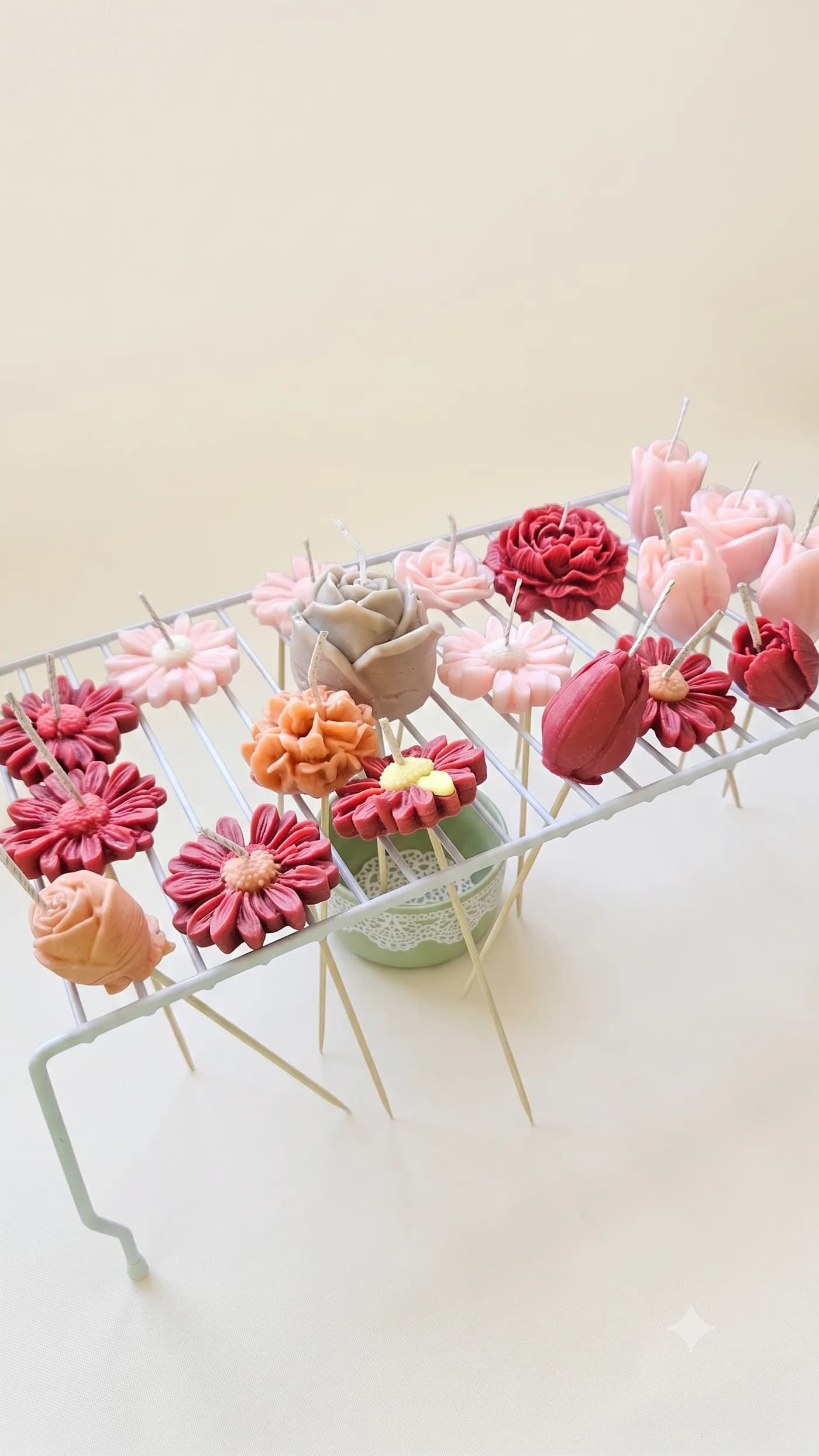Colourful flower candles displayed on slender stems