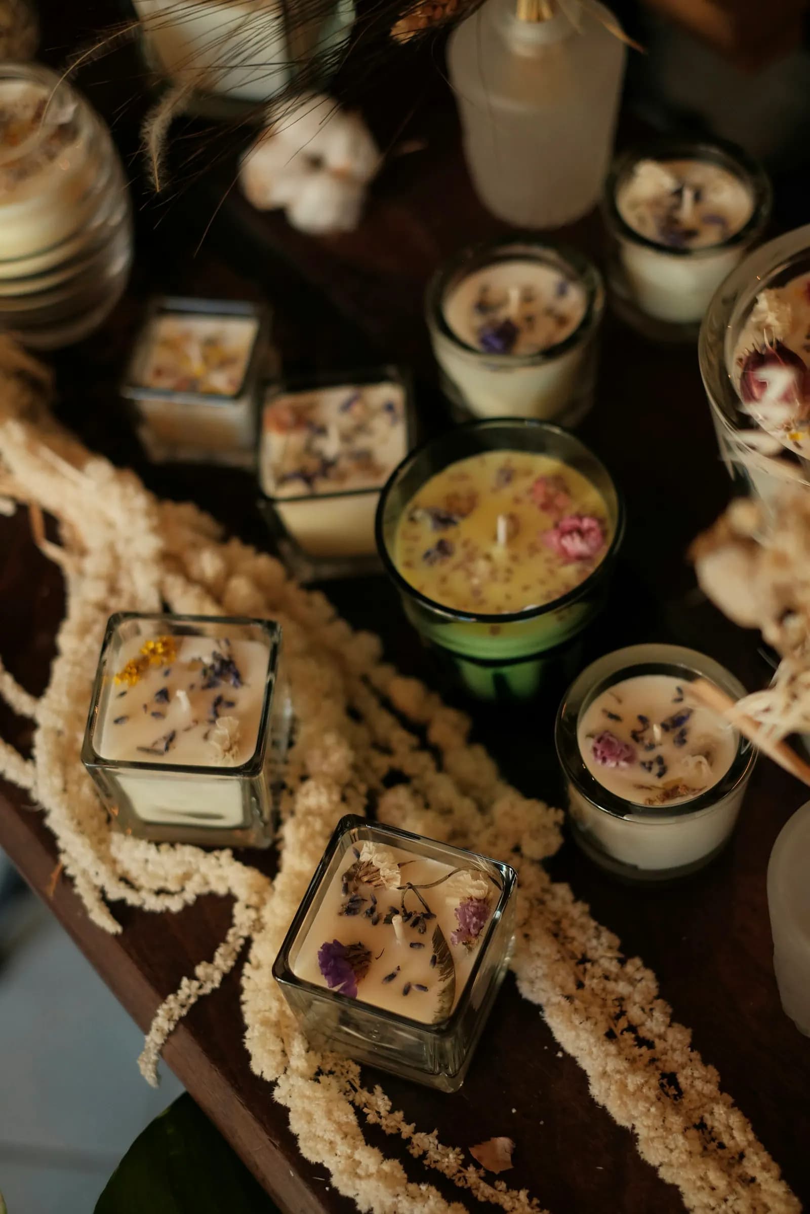 Collection of small botanical candles finished with dried flowers